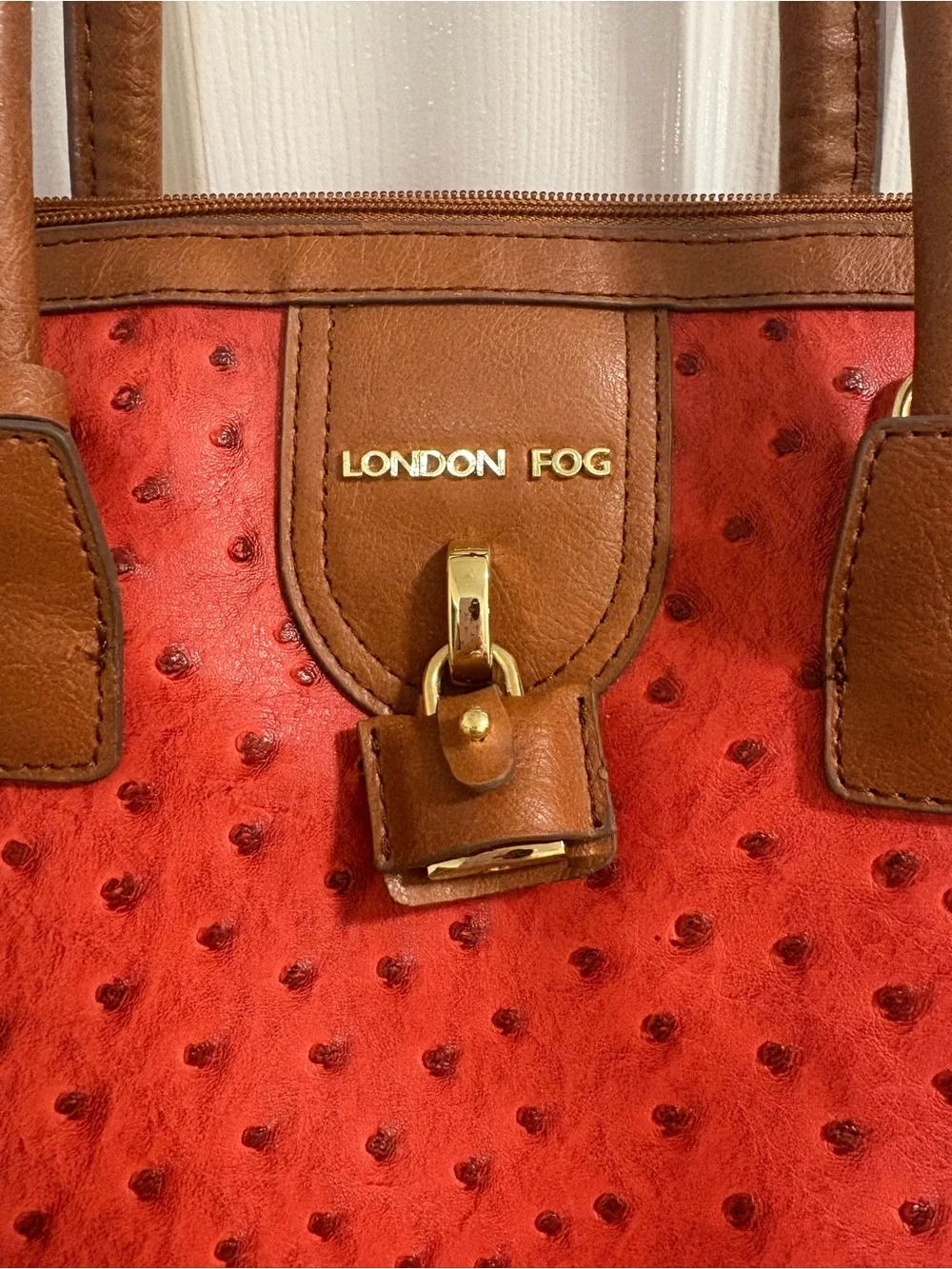 London Fog satchel features a distinctive red ostrich print and lock& key